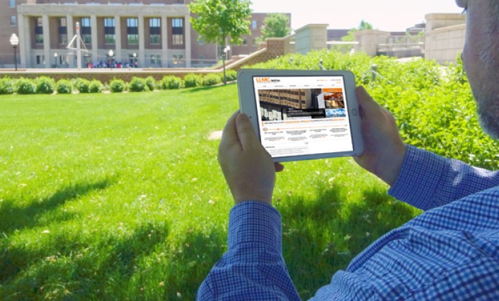 Image of researcher on campus searching LLMC Digital